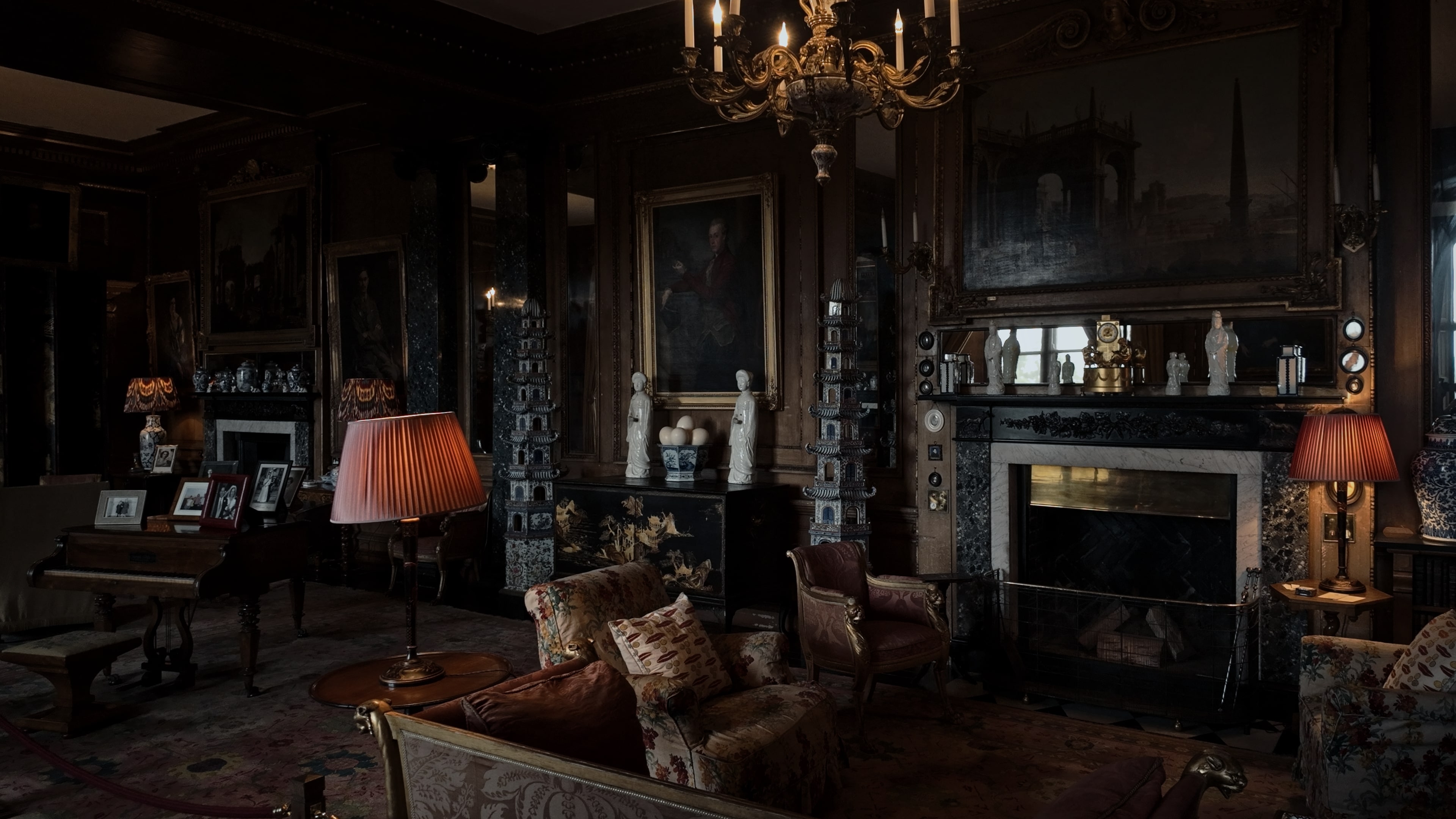 A large room with a series of couches and paintings 