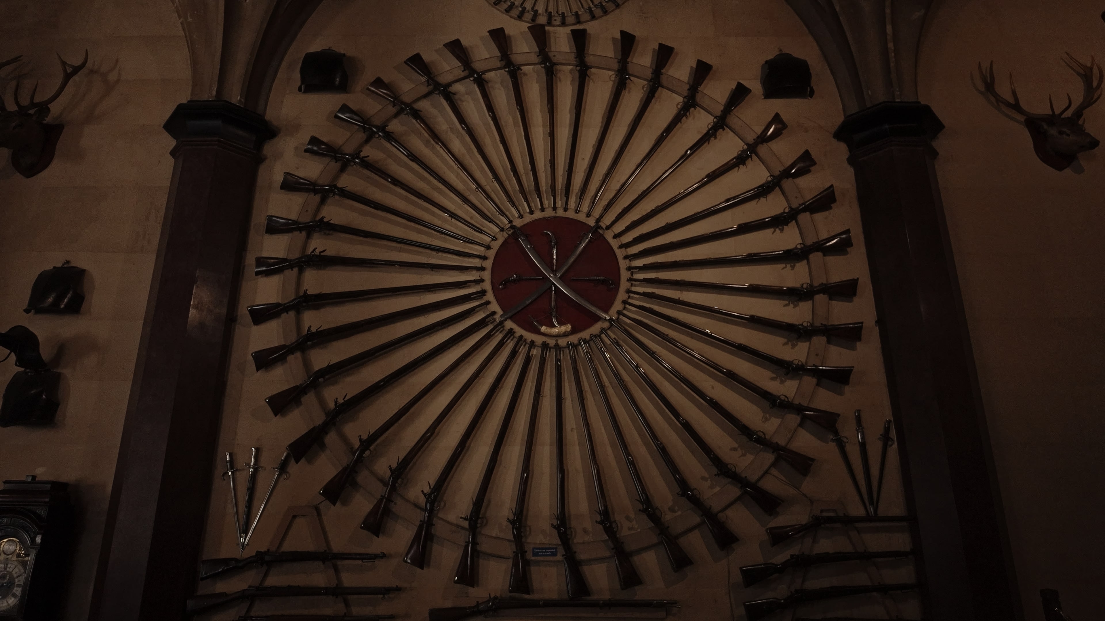 A series of hunting rifles positioned to form a circle with the butts outwards and tips inwards