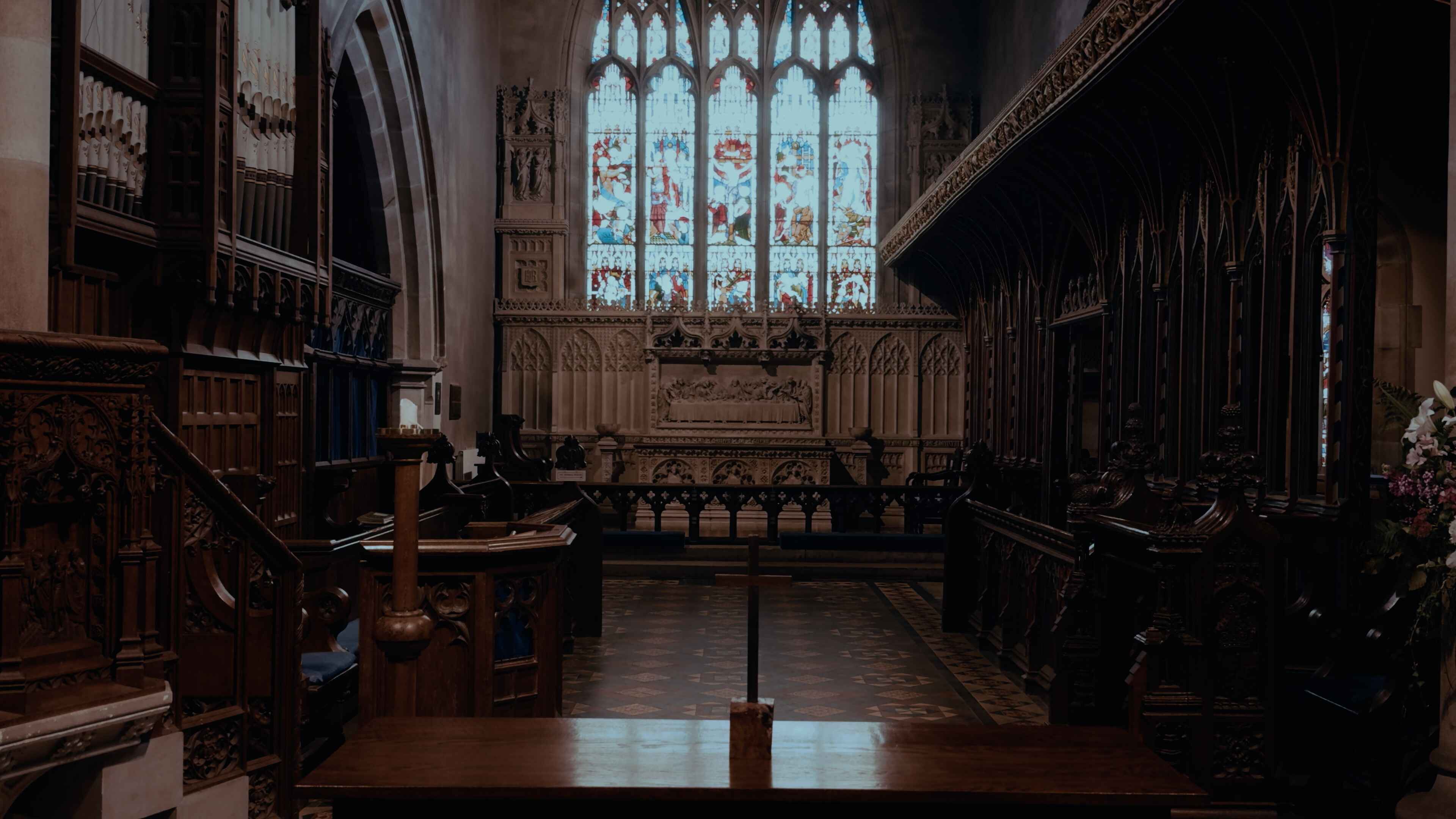 A church front with an altar at the back, confessional to the left and choir section to the right