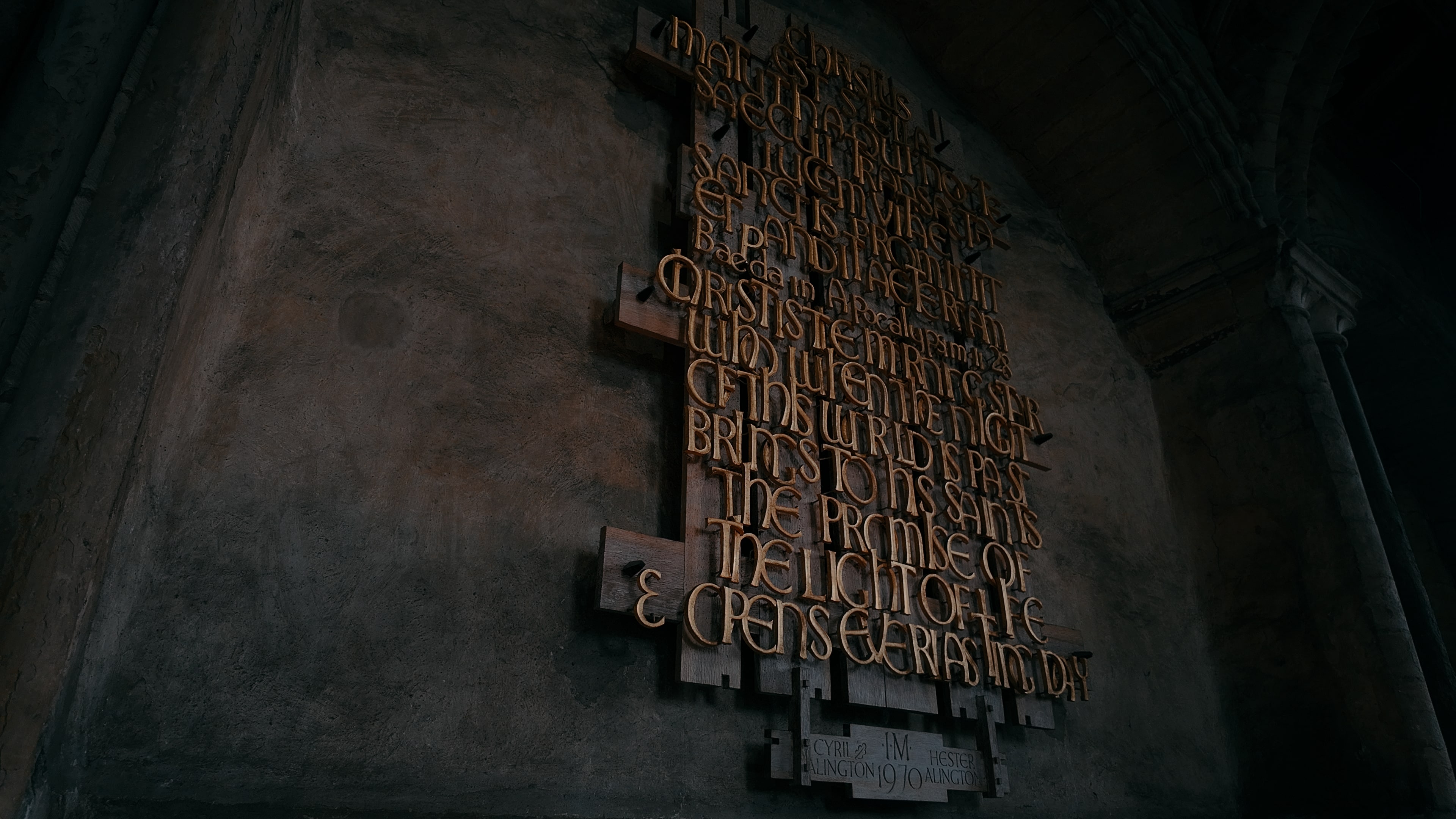Latin inscriptions fixed as bronze lettering upon a wooden plaque