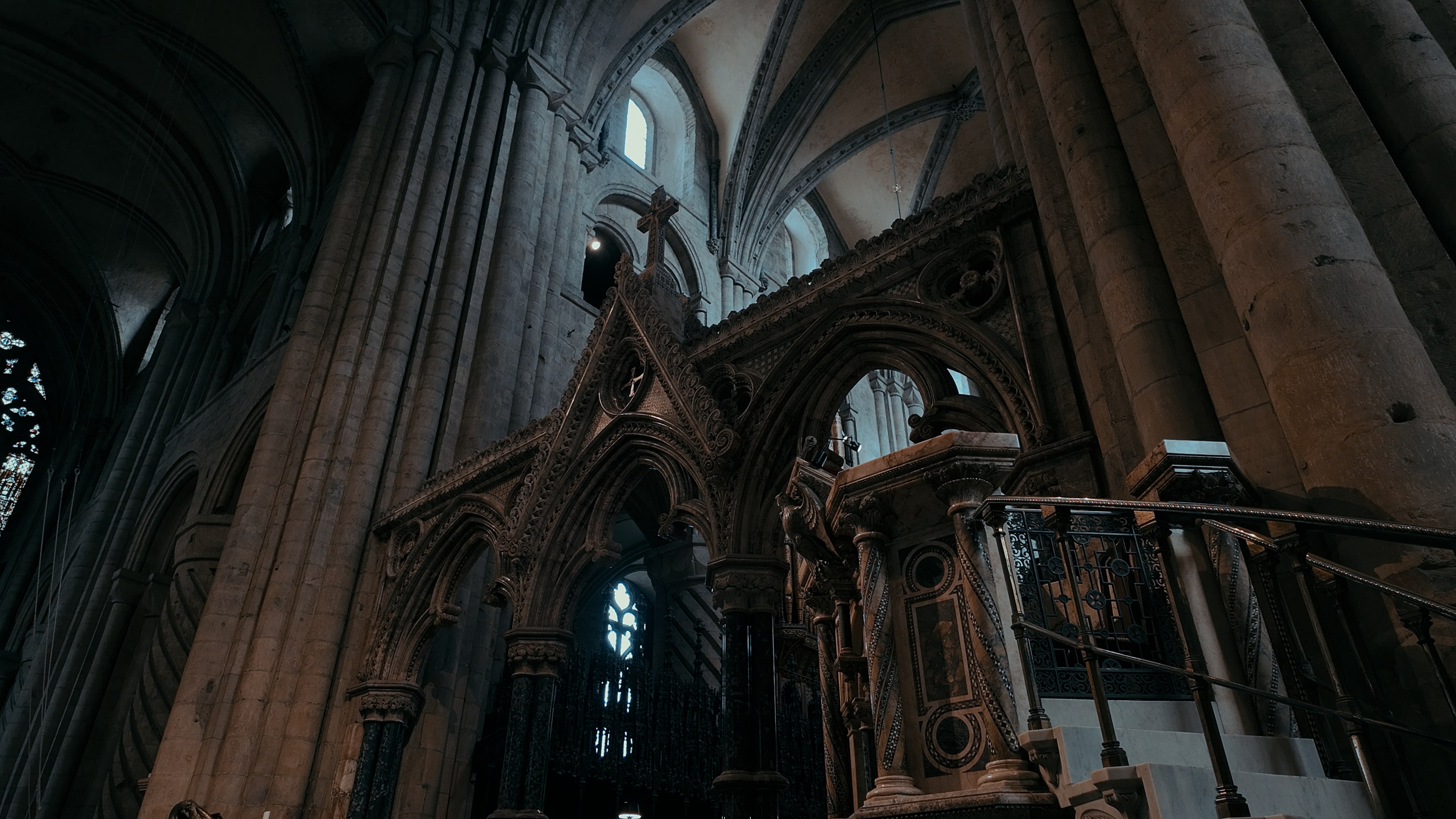 The entrance to a shrine in a cathedral with the cross of Jesus at the top